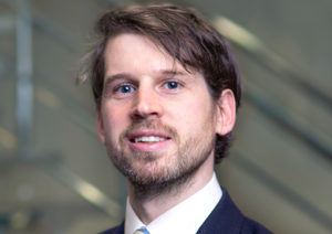 Head shot of Andrew Langan-Newton smiling into camera