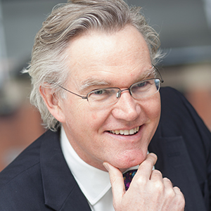 Head shot of Simon Deane-Johns smiling into camera