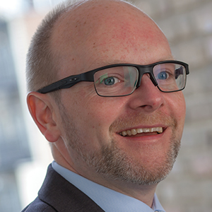 Head shot of Geoff Kermeen smiling and looking away from camera