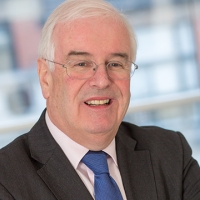 Head shot of Andrew Irvine smiling and looking away from camera