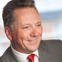 Head shot of Brian Palmer smiling and looking away from camera