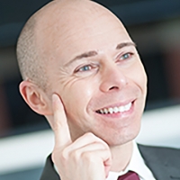 Head shot of Bryan Rickman smiling and looking away from camera