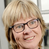 Head shot of Carolyn Bertin smiling and looking away from camera