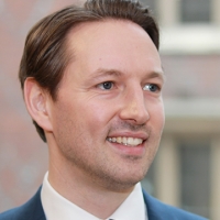 Head shot of Charlie White smiling and looking away from camera