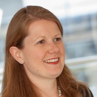 Head shot of Claire O'Flinn smiling and looking away from camera