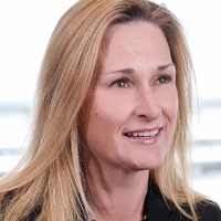 Head shot of Clare Lucas smiling and looking away from camera