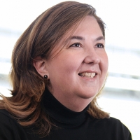 Head shot of Deborah Swanwick smiling and looking away from camera