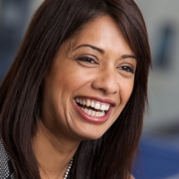 Head shot of Dee Sian smiling and looking away from camera
