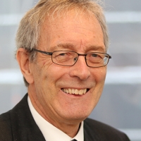 Head shot of Geoffrey Davies smiling into camera