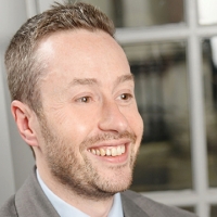 Head shot of Graham Goldspink smiling and looking away from the camera