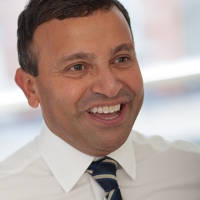 Head shot of Jimmy Desai smiling and looking away from camera