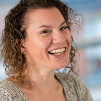 Head shot of Katie Cohen smiling and looking away from camera