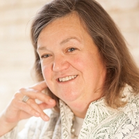 Head shot of Katy Jones smiling and looking away from camera