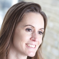 Head shot of Lara Cole smiling and looking away from camera