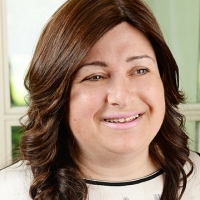 Head shot of Lisa Raymond smiling and looking away from camera