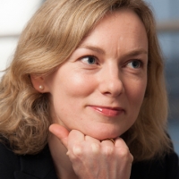 Head shot of Lucy Harrold smiling and looking away from camera