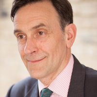 Head shot of Paul Renney smiling and looking away from camera