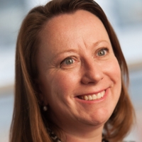 Head shot of Rebecca Tinham smiling and looking away from camera