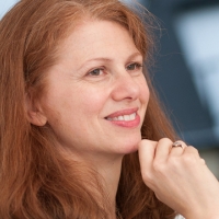 Head shot of Rose Alexander smiling and looking away from camera