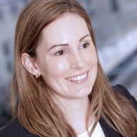 Head shot of Sarah Needham smiling and looking away from camera