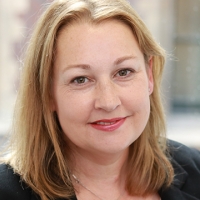 Headshot of Sharron Carle wearing a black top looking in to the camera