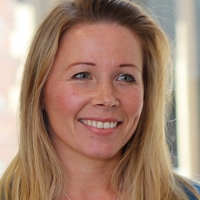 Head shot of Stephanie Hitch smiling and looking away from camera
