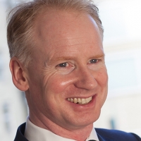 Head shot of Steven Conway smiling and looking away from camera