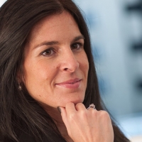 Head shot of Susana Lajusticia smiling and looking away from camera