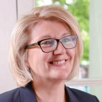 Head shot of Susannah Sheppard smiling and looking away from camera