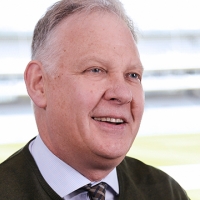Head shot of Tony Houghton smiling and looking away from camera