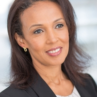 Head shot of Tsige Berhanu smiling and looking away from camera