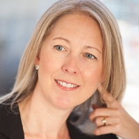 Head shot of Vicky Clark smiling and looking away from camera