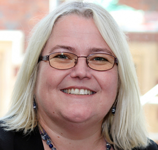 Head shot of Jackie Vanhinsbergh smiling into camera