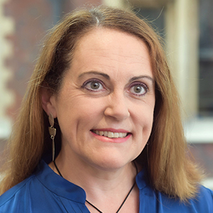 Head shot of Caroline Graham smiling and looking away from camera