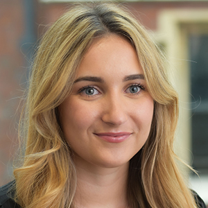 Head shot of Daisy Payne smiling and looking away from camera