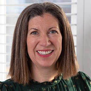 Headshot of Laura Rogers wearing a green top smiling into the camera