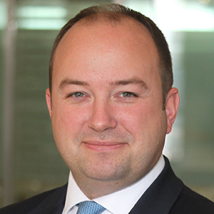 Head shot of Simon Sutcliffe smiling into camera