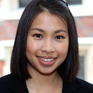 Head shot of Nateecha Powdthavee smiling into camera