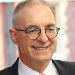 Head shot of Gerard Cukier smiling and looking away from camera