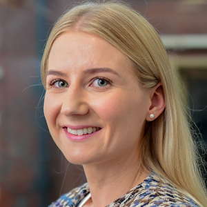 Headshot of Carys Mason turned to the side looking at the camera