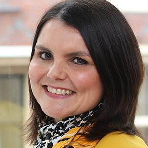 Head shot of Kelly Sayers smiling into camera