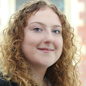 Head shot of Samantha Hall-Burnett smiling into camera