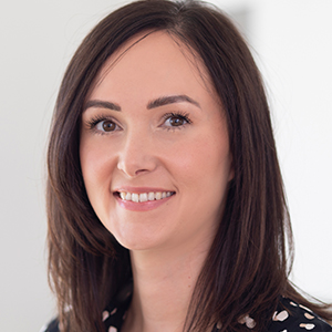 Head shot of Katie Tibbitts smiling into camera