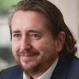 Head shot of Simon Chalkley looking away from camera