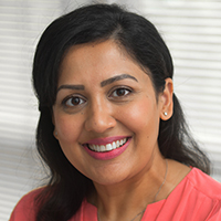 Headshot of Sheena Ray wearing a pink top looking into the camera