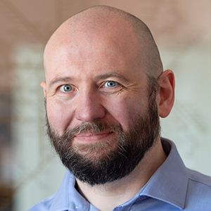 Head shot of Alasdair Watson looking into camera