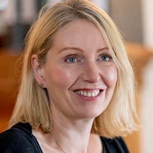 Head shot of Alexandra Carn smiling and looking away from camera