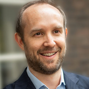 Head shot of Nicholas Barclay smiling and looking away from camera