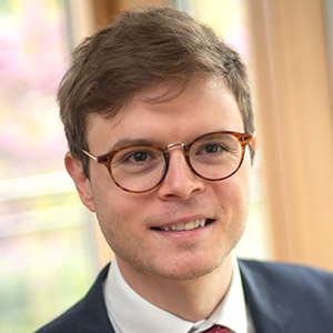 Head shot of Adam Tarr smiling and looking away from camera