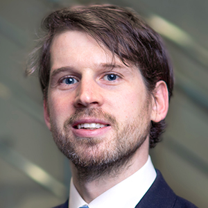 Head shot of Andrew Langan-Newton smiling into camera